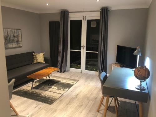 a living room with a couch and a table at Adam And Eve Street Apartment in Cambridge