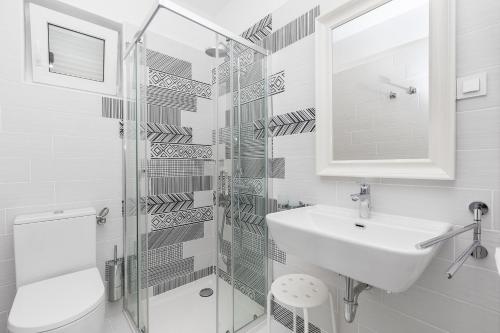 プナトにあるVilla Andreaの洗面台と鏡のある白いバスルーム