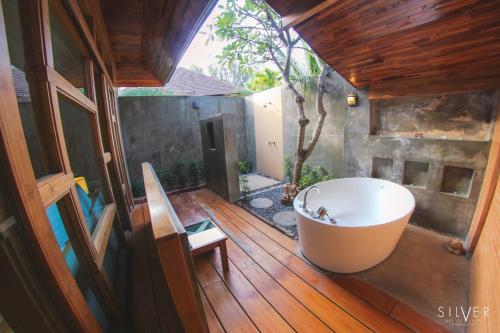 a bathroom with a tub on a wooden deck at Bundhaya Villas in Ko Lipe