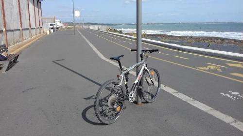 a bike parked next to a pole on a street at DDenko Apartment in Burgas City