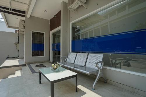 a living room with a couch and a table at RedDoorz Plus near Palembang Airport 3 in Palembang