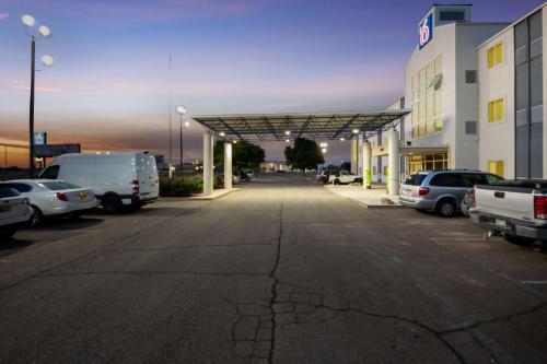 a parking lot with cars parked in front of a building at Motel 6-Roswell, NM in Roswell