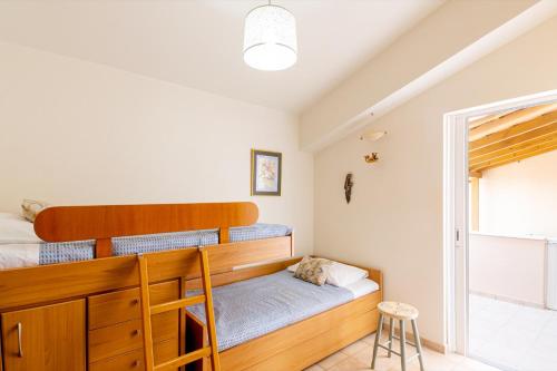 a bedroom with a bunk bed and a window at Villa Aiolos in Palekastron