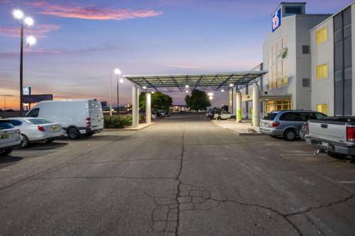 a parking lot with cars parked in front of a building at Motel 6-Roswell, NM in Roswell