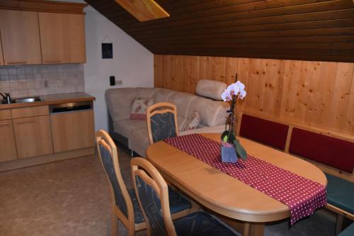 a table and chairs in a kitchen with a couch at Apartment Krobath in Murau