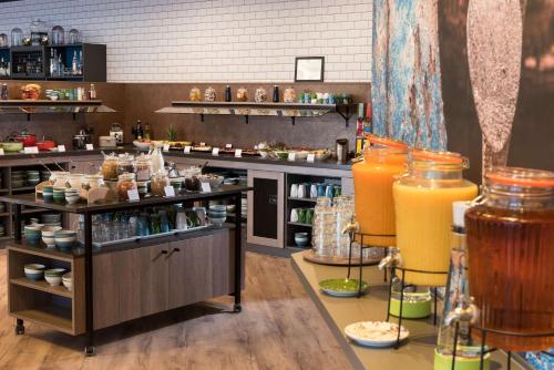 a restaurant with some drinks on display in a room at Ramada by Wyndham Flensburg in Flensburg