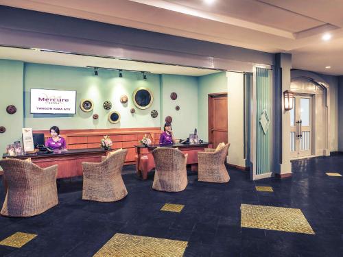 two women sitting at a counter in a waiting room at Mercure Yangon Kaba Aye in Yangon