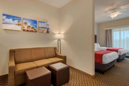 a hotel room with a bed and a couch at Comfort Inn & Suites Fort Myers Airport in Fort Myers