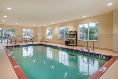 a large swimming pool in a hotel room at Comfort Inn & Suites Fort Myers Airport in Fort Myers