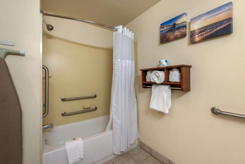 a bathroom with a shower and a shower curtain at Comfort Inn & Suites Airport in Fort Myers