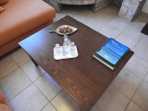 a wooden coffee table with a book and a plate of fruit on it at Villa Aiolos in Palekastron