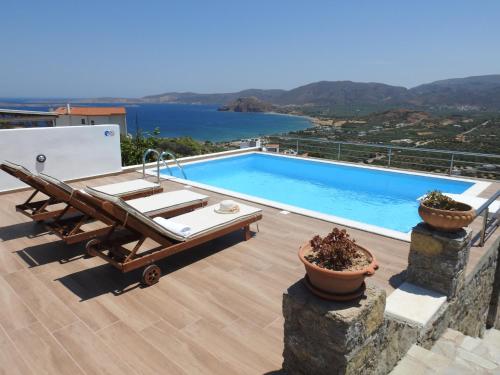 a swimming pool with a view of the water at Villa Aiolos in Palekastron