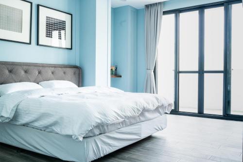 Ένα ή περισσότερα κρεβάτια σε δωμάτιο στο Grace Garden Coffee Homestay