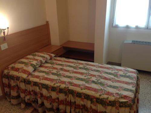 a bedroom with a bed with a quilt on it at Hotel Castello in Mesagne