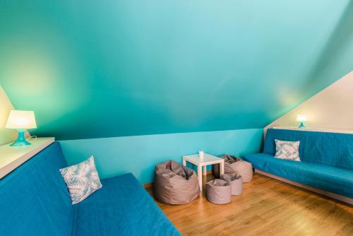 a living room with a blue couch and some bags at Verona in Kąty Rybackie