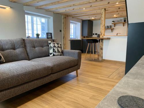 a living room with a couch and a table at The Old Post Office in Whitby