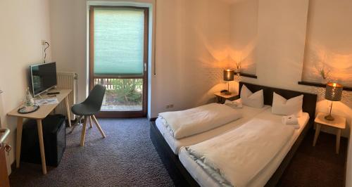 En eller flere senge i et værelse på Hotel Augsburg Langemarck