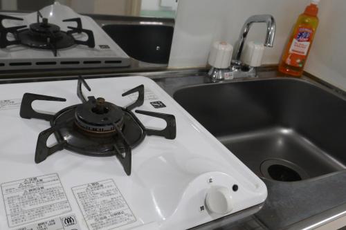 a tea pot sitting on top of a kitchen stove at Tokyo Sakura hotel in Tokyo