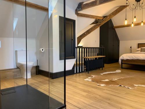 a bedroom with a bed and a glass wall at The Old Post Office in Whitby