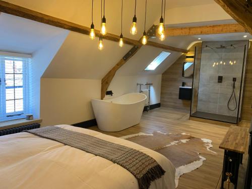 a bedroom with a bath tub and a large bed at The Old Post Office in Whitby
