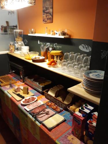 a bakery counter with different types of pastries on it at Hostal La Lluna in Arenys de Mar