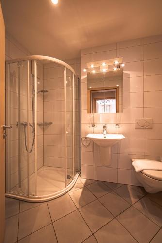 a bathroom with a shower and a sink at Chalet Bella Vista 4 in Wengen