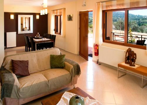 a living room with a couch and a table at Helidonia Villas in Pigi