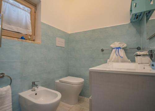 a bathroom with a sink and a toilet at Bebcatia in Agropoli