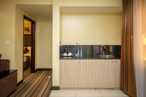 a kitchen with a counter and a sink in a room at The Clarion Hotel in Nairobi