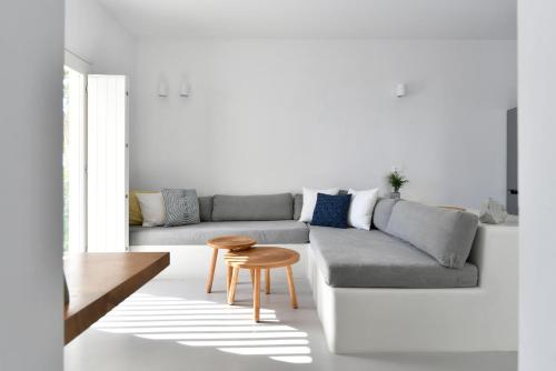 a living room with a couch and a table at Thiro Santorini in Fira