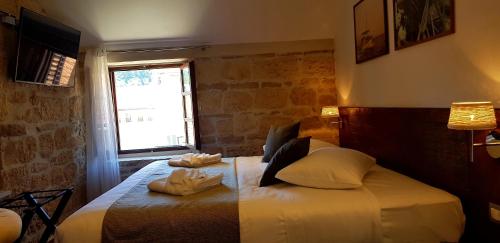 a bedroom with a bed with two towels on it at San Teodoro in Korčula