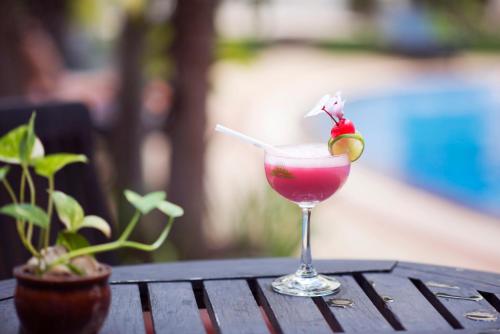 a drink in a glass sitting on a table at Baitong Heritage Hotel in Siem Reap