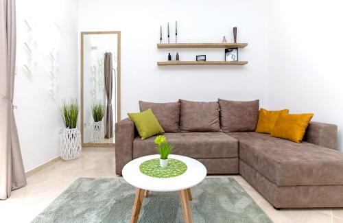 a living room with a couch and a table at Apartments Marilu in Kotor