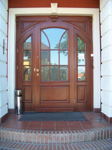 a wooden door with a window on a house at Sapphire Apartment in Rewal