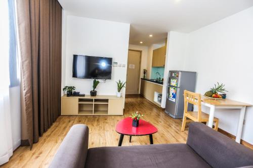 a living room with a couch and a table at Ficus Suites in Hanoi