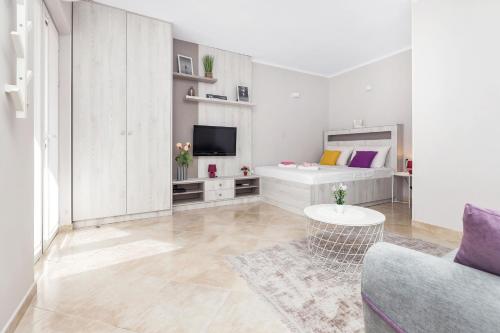 a living room with a couch and a tv at Apartments Marilu in Kotor