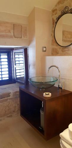 a bathroom with a glass bowl sink on a counter at San Teodoro in Korčula