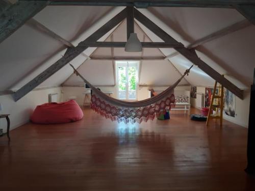 a room with a hammock in a attic at Casa Magnólia in Braga