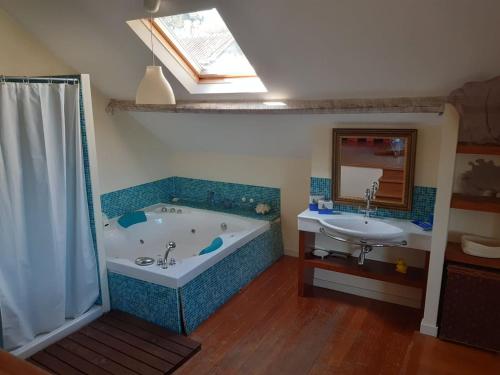 a bathroom with a bath tub and a sink at Casa Magnólia in Braga