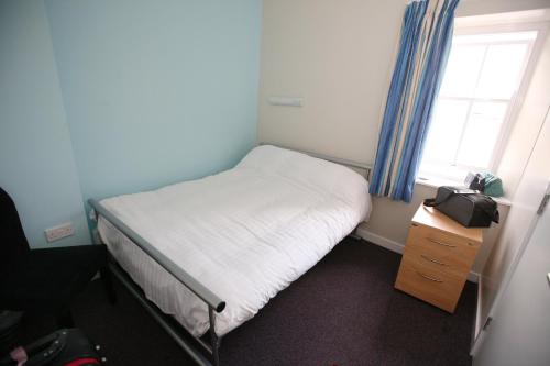 Ένα ή περισσότερα κρεβάτια σε δωμάτιο στο Alnwick Youth Hostel