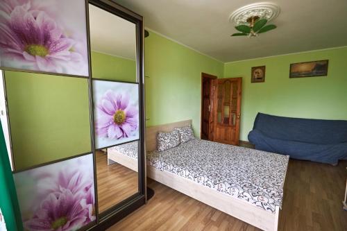 a bedroom with a mirror and a bed in it at Babylon Apartments On Kievskaya Street in Rivne