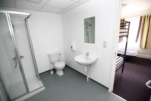 a bathroom with a toilet and a sink and a shower at Alnwick Youth Hostel in Alnwick