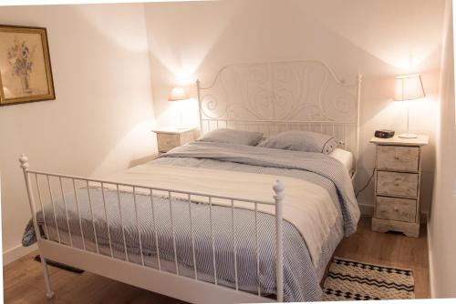 a bedroom with a white bed with a white headboard at River Ebro Apartments in Móra d'Ebre