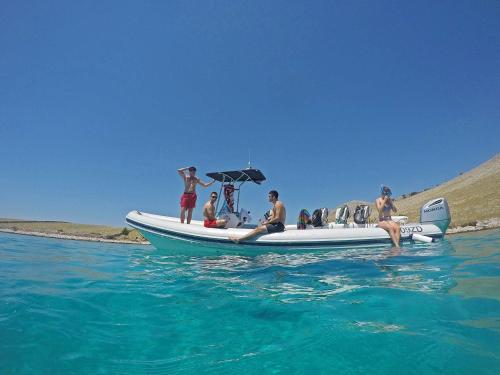 a group of people on a boat in the water at OrkulaBliss Apartments in Pašman
