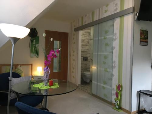 a room with a glass table and a bathroom at Ferien in Sachsen in Bischofswerda