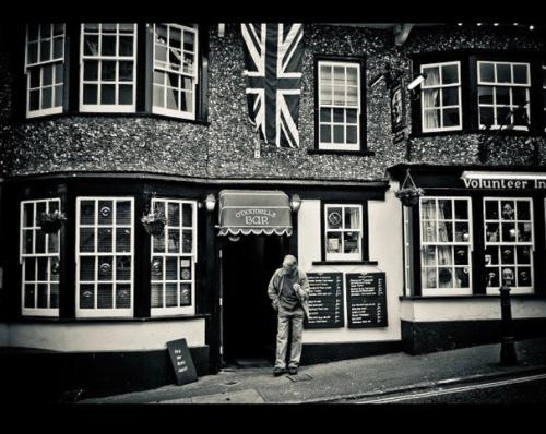 a man standing in front of a building at Room at the Inn in Lyme Regis