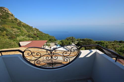 a bench on a balcony with a view of the ocean at Il Cigno Affittacamere Bed & Breakfast in Ponza