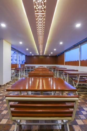 a group of tables and chairs in a room at Kensington Suites in Bengaluru