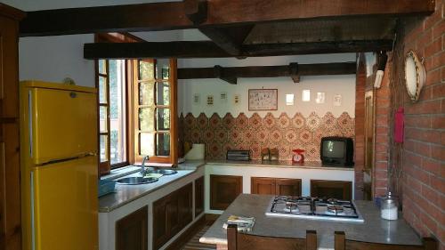 a kitchen with a yellow refrigerator and a stove at Casa Lalla natura e relax in Cusano Mutri