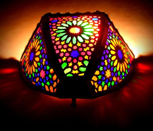 a lamp that has a stained glass window on it at Riad Al Nour in Marrakech